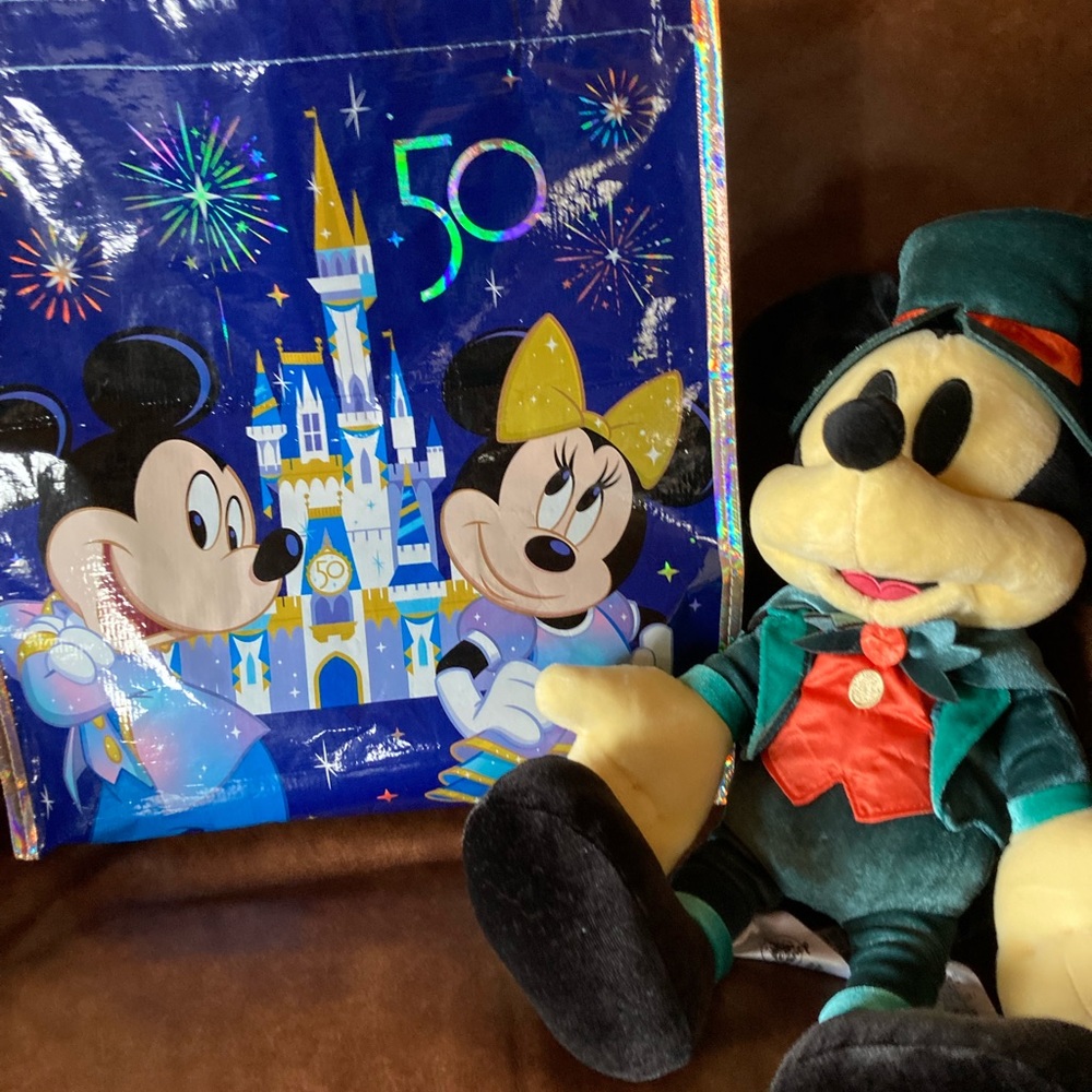 Mickey Mouse 50 year celebration in costume with Anniversary bag.